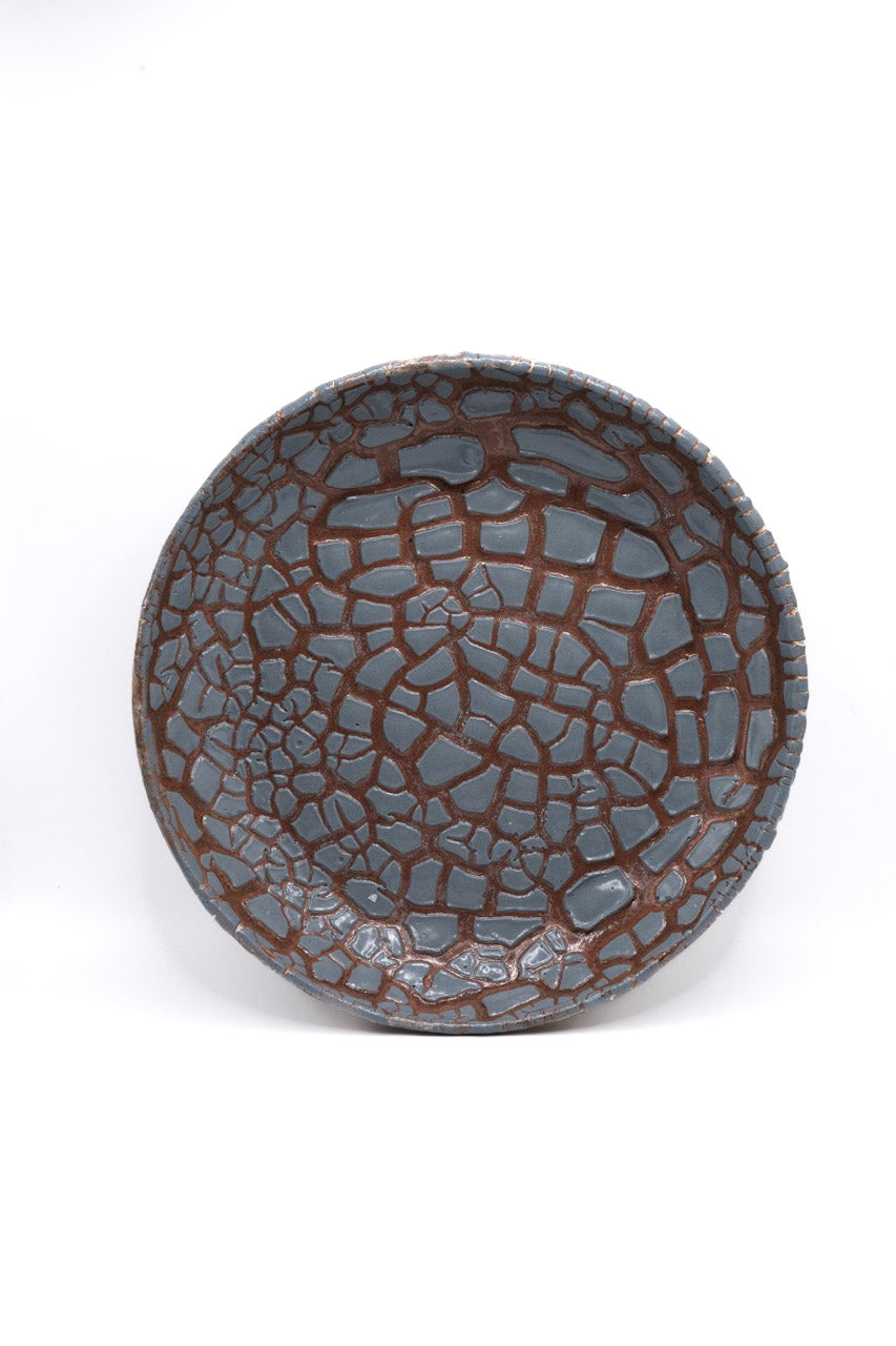Fired bowl with grey crawl glaze on dark clay. Crawling texture when fired to cone 5 or 6.