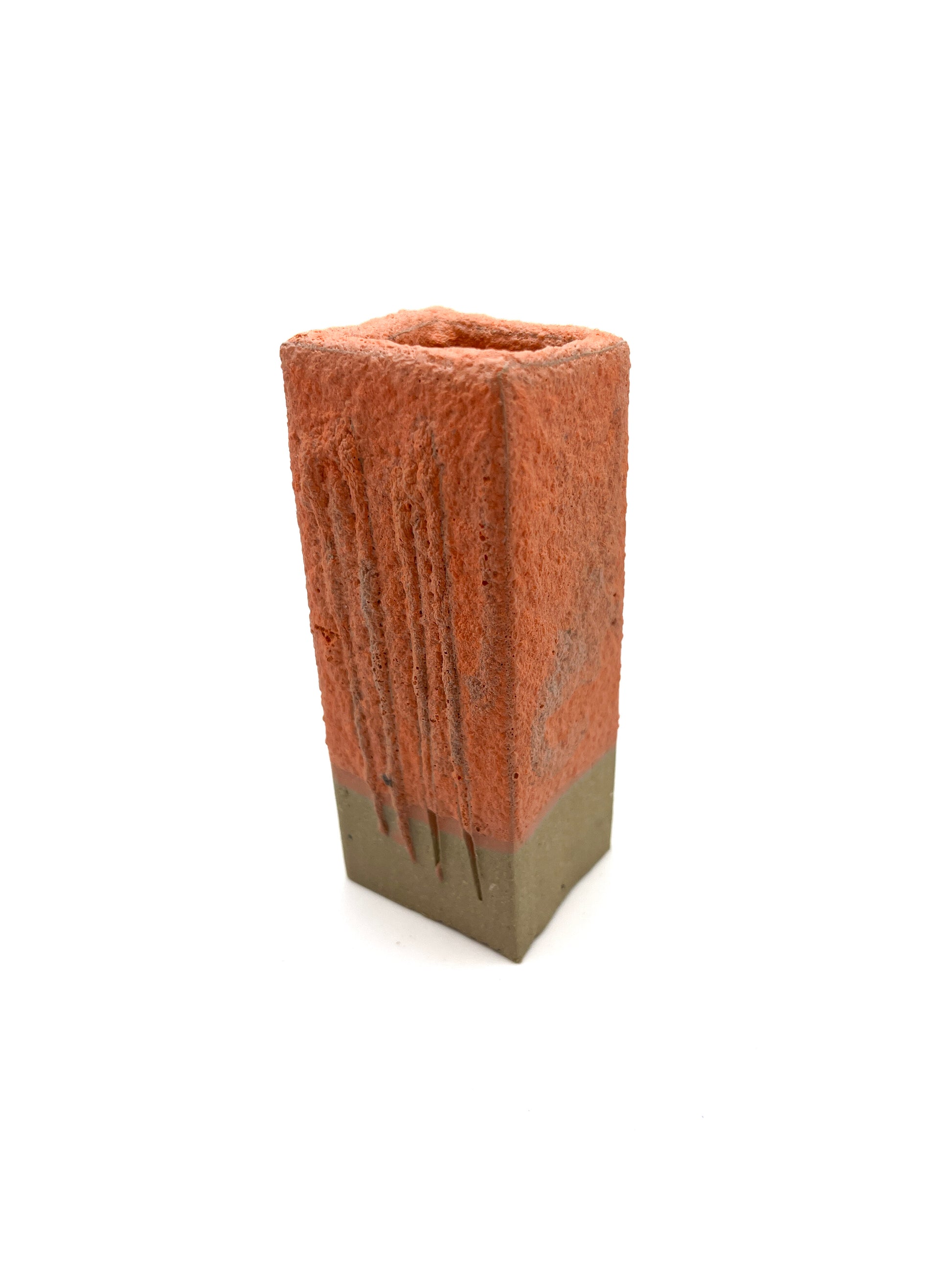 Fired test column for orange mini-puff glaze on dark clay. Fuzzy texture when fired to cone 5 or 6.