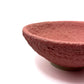 Fired bowl with red puff glaze on dark clay. Cloud-like texture when fired to cone 5 or 6.